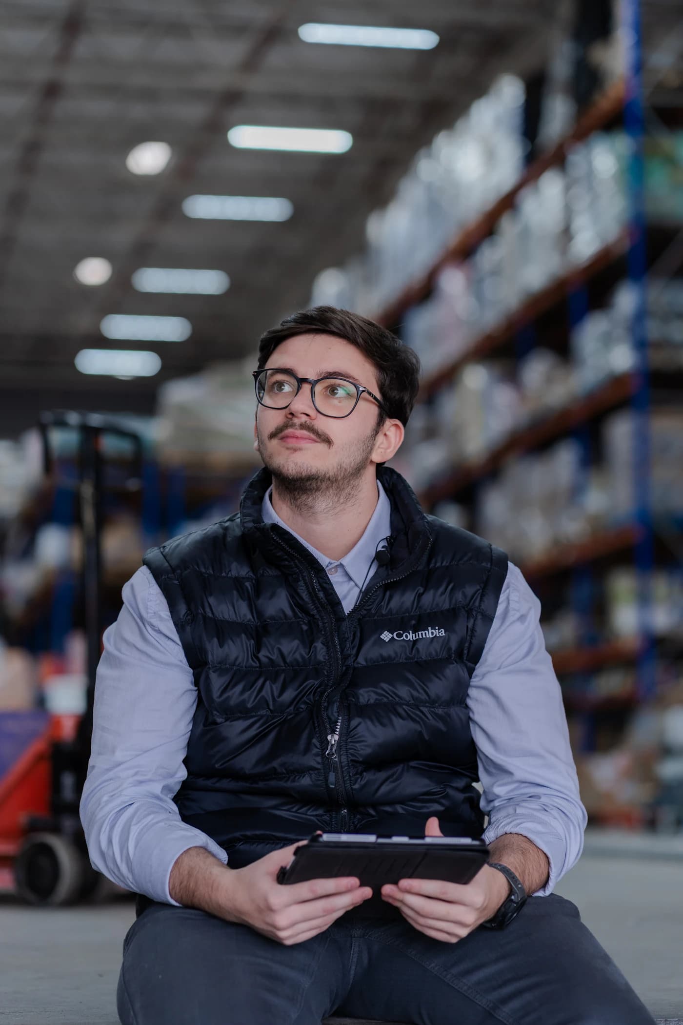 A worker using a tablet in a warehouse