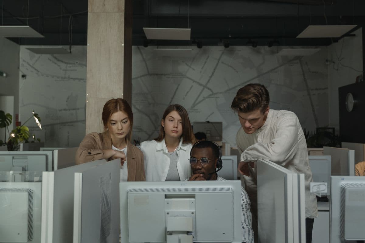 Technology support colleagues assessing a shared workstation
